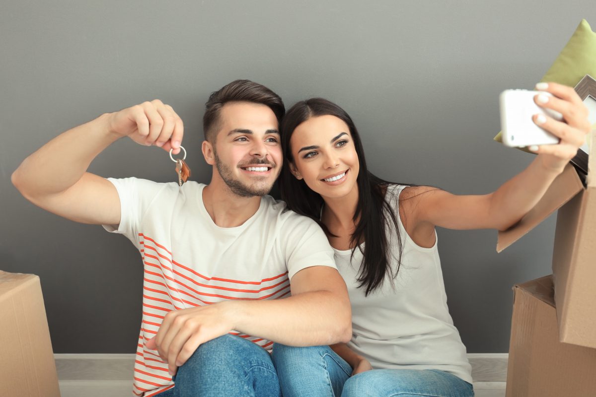 Couple taking a selfie with their new house keys