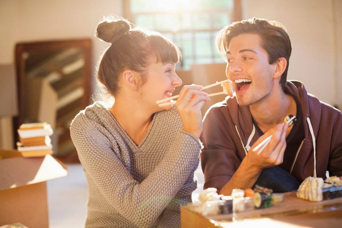 Couple eating sushi new shared home